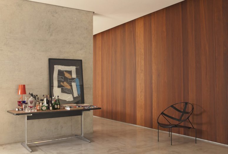 A slatted wooden wall in a rich shade makes the space cozier and softer