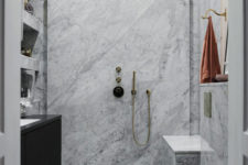 08 The bathroom is small, clad with white marble and with brass fittings for a chic look