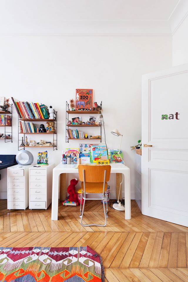The kid's room is bright and colorful, with various pattern and comfy furniture