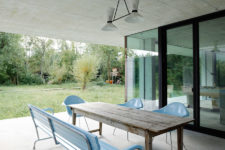08 The terrace is simple, with sky blue seats and a rustic wooden table