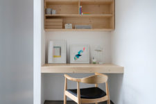 08 The workspace is with a built-in desk and a cabinet over it, everything is simple and laconic