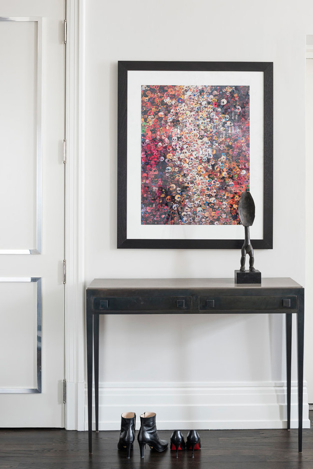 The entryway features a very bold artwork and a metal console