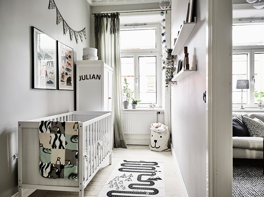 The kid's space is small, with colored artworks and textiles and a printed rug