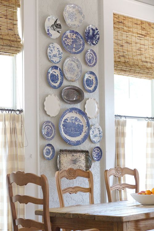 blue and white plates and silver trays for decorating a dining space