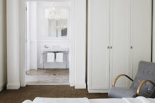 11 The bathroom is decorated in white and neutrals, there’s a vintage glam chandelier