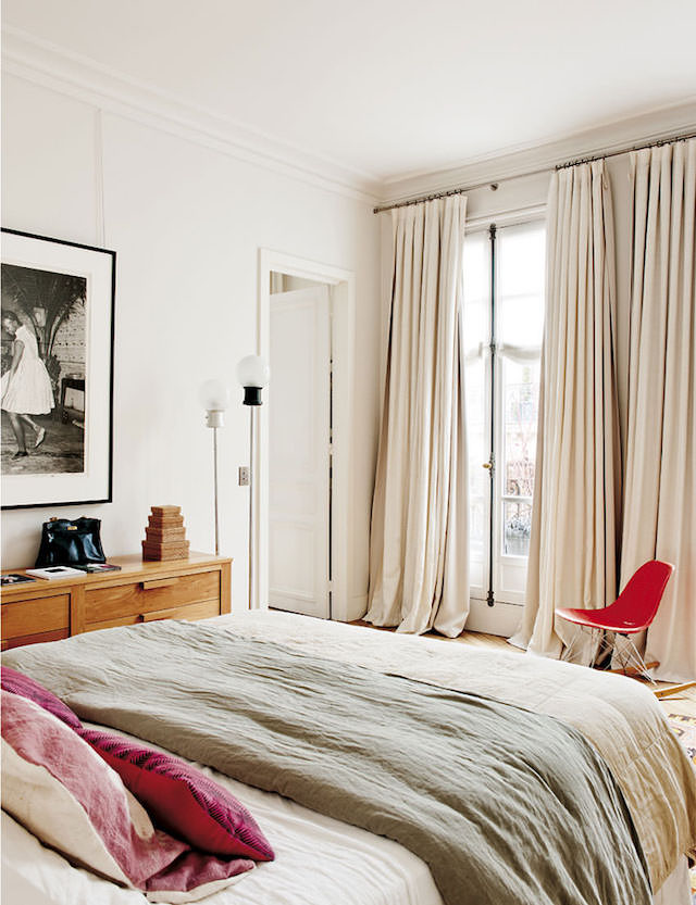 The master bedroom is very soft, creamy and inviting, with red accents