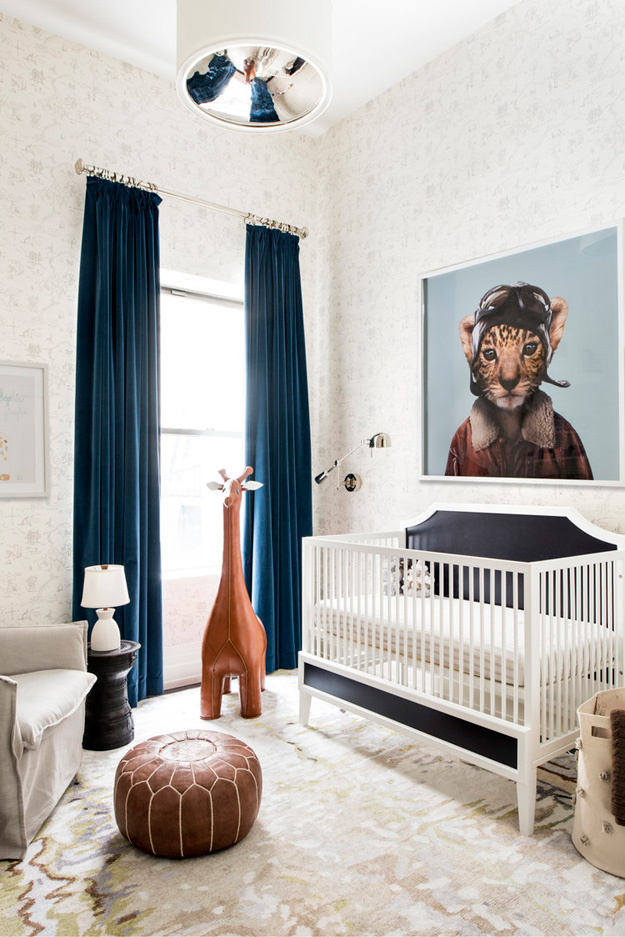 Even the stylish kid's room features a cool artwork and a leather giraffe