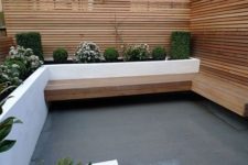 12 a cozy wind-sheltered area with a bench and a white modern planter