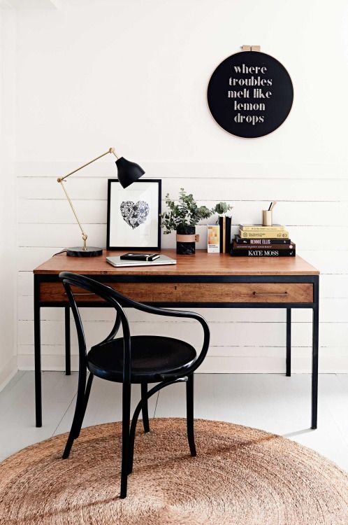 a modern desk in black framing and with stained wood