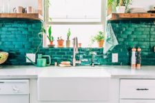 13 a brick backsplash painted in emerald color echoes with greenery