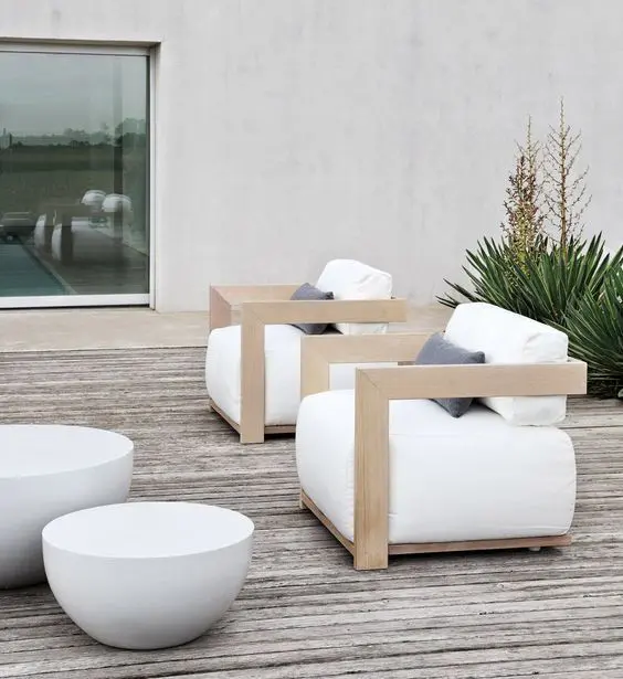 Cool light colored wooden chairs with armrests and white upholstery