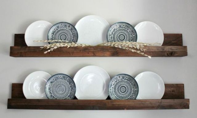 dark stained wooden shelves with plates for wall decor