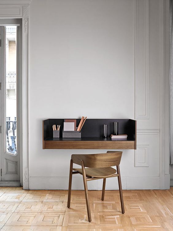 a modern floating desk with a black tabletop looks wow