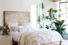 17 a wooden bed with whitewashed decor creates a boho feeel