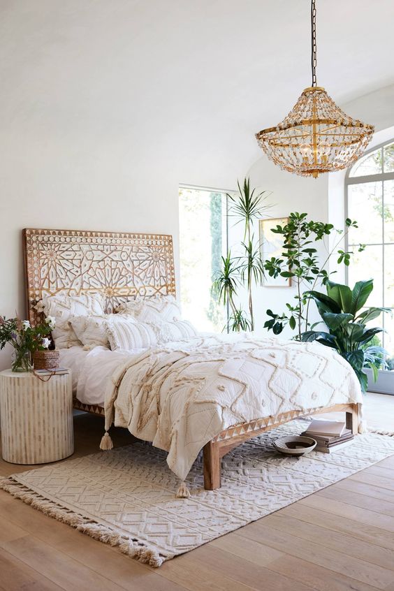 a wooden bed with whitewashed decor creates a boho feeel