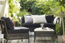 18 Kungsholmen lounge set with black upholstery contrasts with greenery around