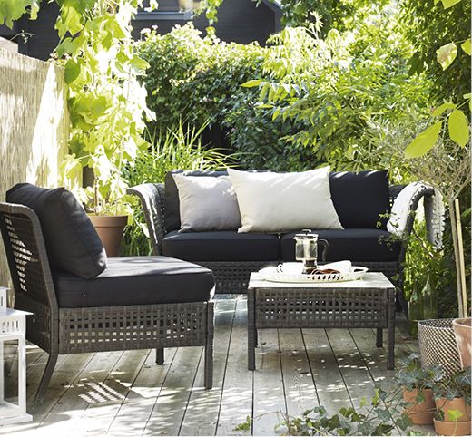 Kungsholmen lounge set with black upholstery contrasts with greenery around