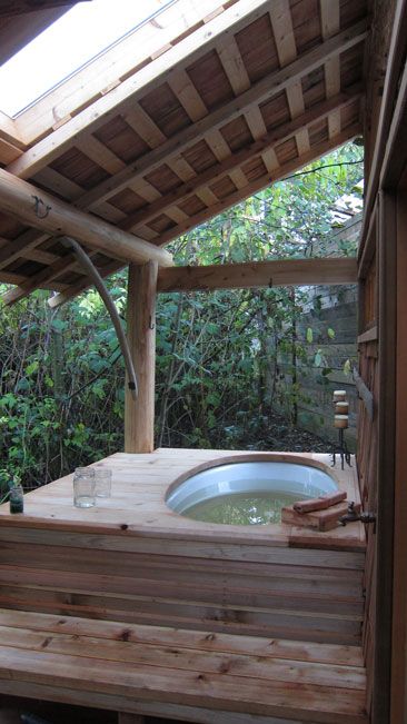 outdoor jacuzzi with a wooden deck and a roof over it gives a natural feel to the space