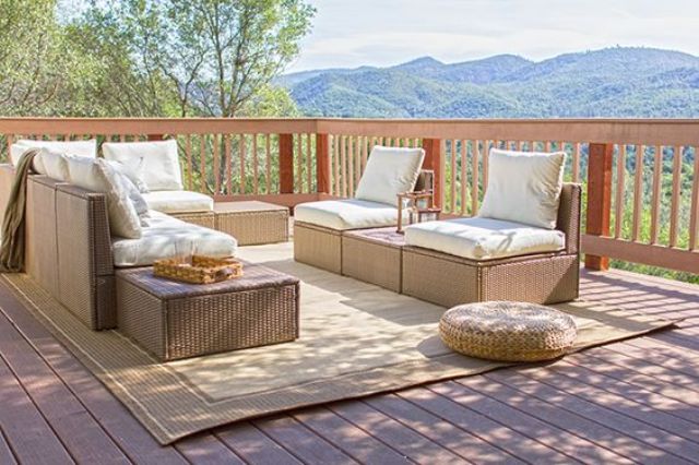 a terrace furnished with Ikea Arholma and a wicker ottoman