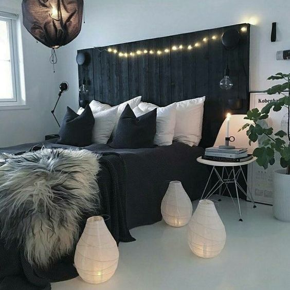 A black pallet bed can be DIYed and makes a bold statement in a light colored room