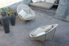 21 rounded white wicker chairs with creamy cushions
