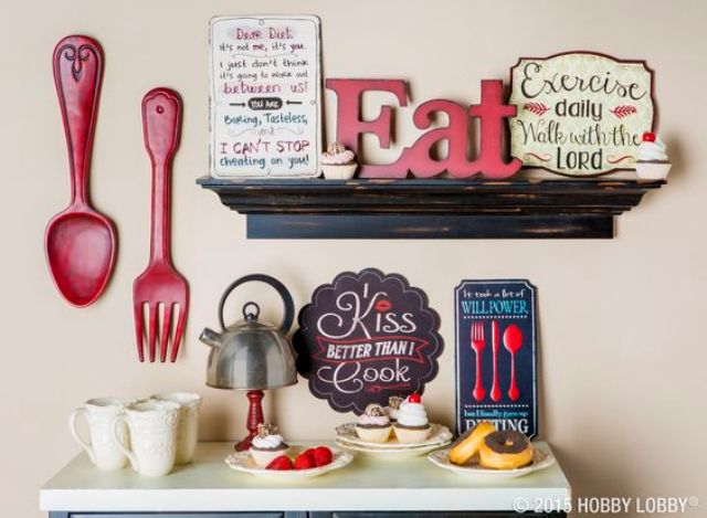 oversized red utensils, an EAT sign and some more wooden ones