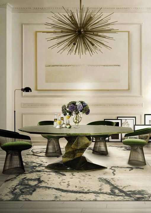 A sculptural table in the shades of green with a round top and a an eye catchy leg