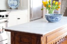 28 a vintage rustic table with carved legs and a marble counter