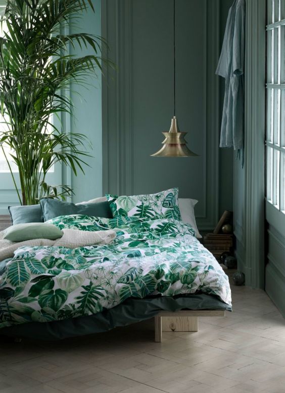 a large plant and botanical bedding that echoes with it