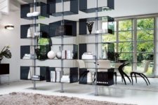 01 The Domino bookcase is made of metal poles and glass boxes on them