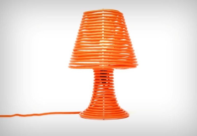 This Coil Lamp is made of an acrylic base covered with bold orange extension cord, which isn't only a part of lamp but also the design feature