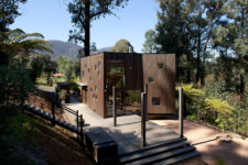 01 This vacation home clad with dark timber features a lot of piercings and glazings to bring the views inside and merge with nature