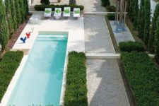 02 a gravel-covered backyard with perfect greenery and a small narrow pool