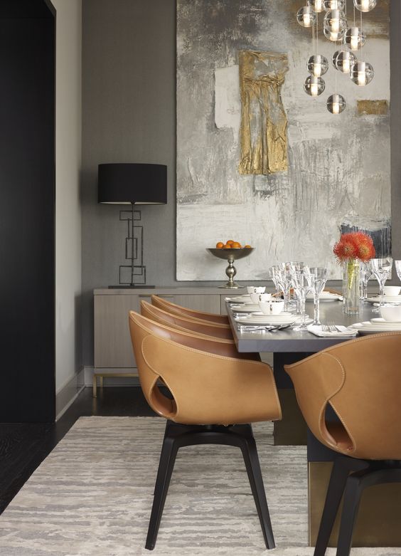 brown leather chairs on black wooden legs add texture to the space