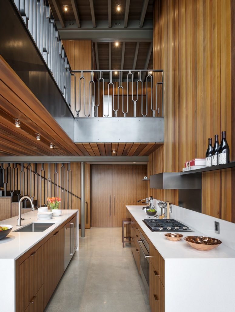 The kitchen is done in warm wood and sleek white for a contrast, the shelving is open