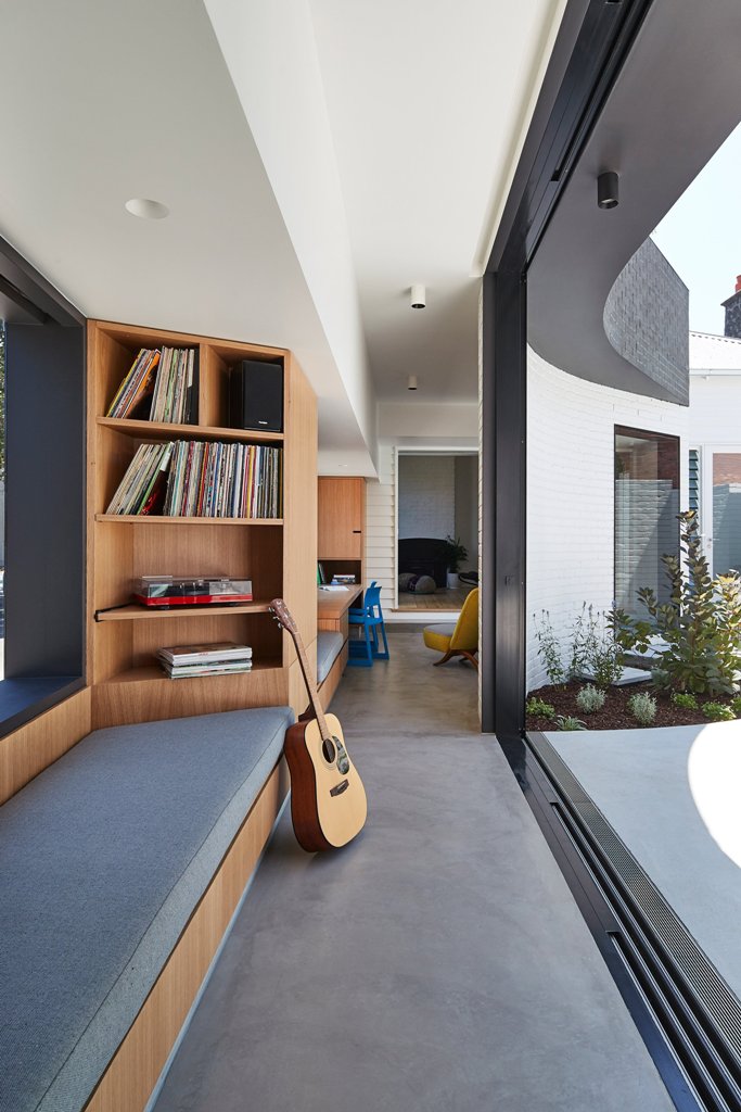 There's a corridor that functions as a reading nook and opens to the courtyard