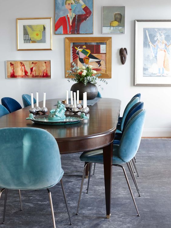 blue and turquoise upholstered chairs create a mood in this dining room