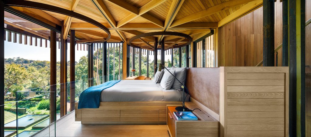 The bedroom is designed as if it's a real tree house, it's located right under the roof and has magnificent views
