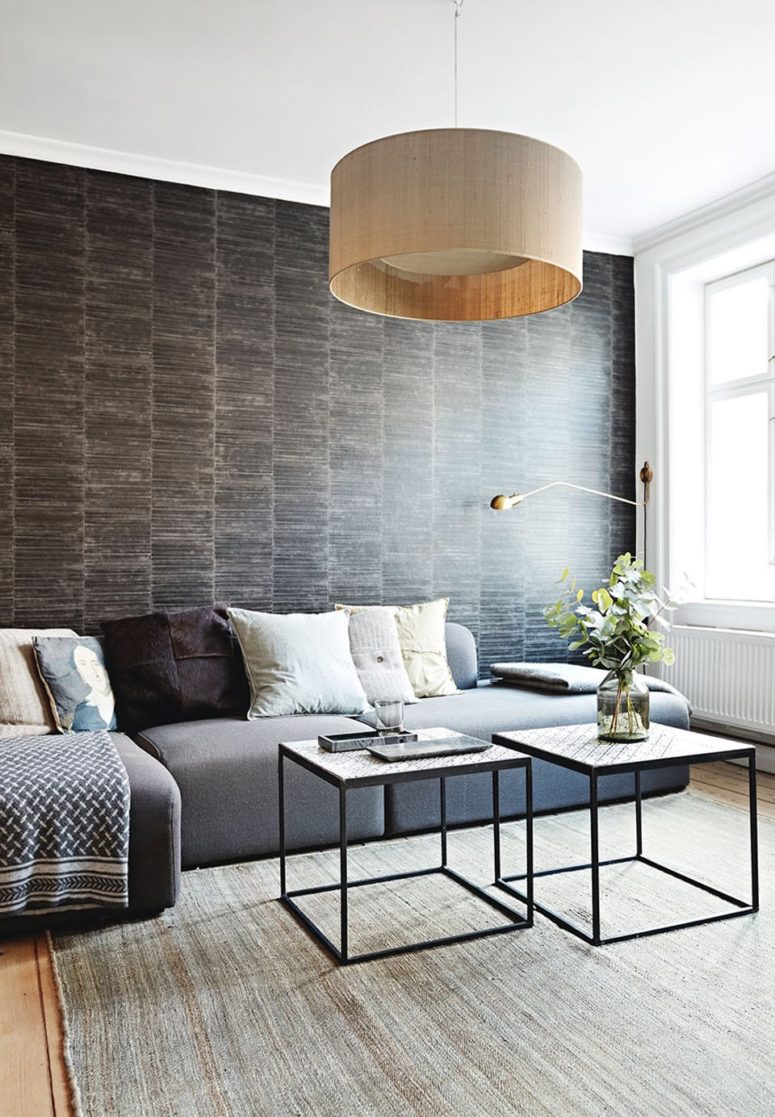 The living room is another space with an eye-catchy wallpaper wall, and this one imitates chocolate wood planks