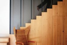 05 The stairs is made of light-colored wood, there’s a wicker chair and a restored wooden ceiling for coziness