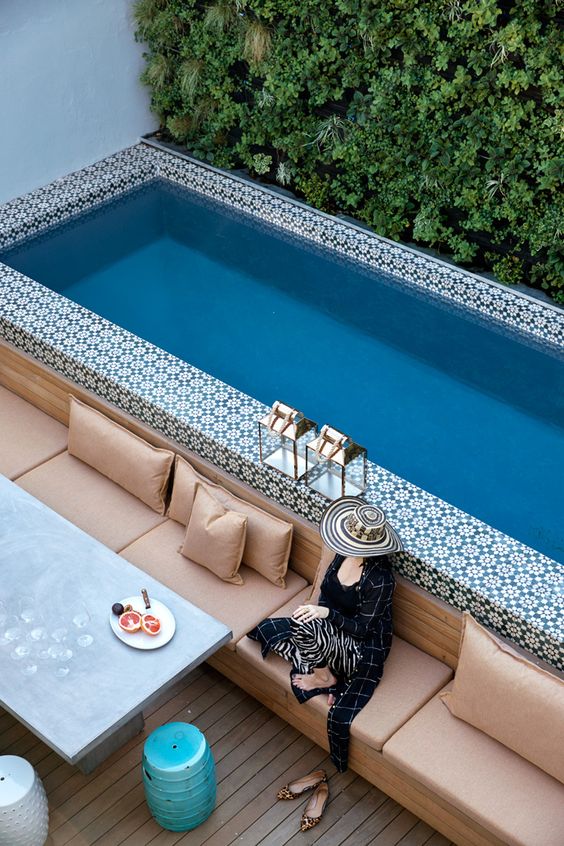 A bold Moroccan tile clad pool in a small courtyard