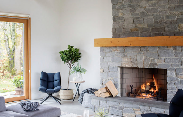The gorgeous stone clad fireplace is working, and it not only adds coziness but also reminds as that this is a rustic space