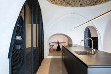 08 The ancient stone ceilings are neighboring with modern metal net doors and minimalist lights