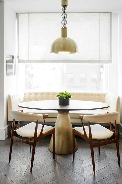 The dining space is mid-century modern, with brass details for a chic look
