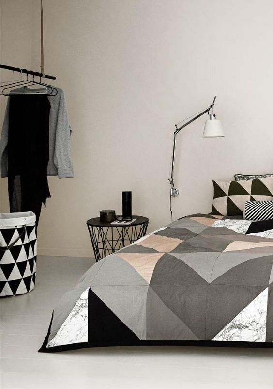 grey, black, white and blush large scale triangle bedding for a modern bedroom
