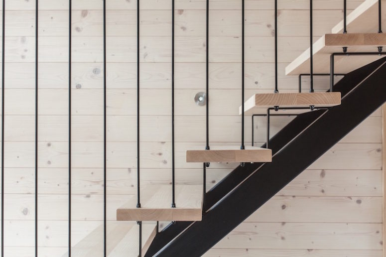 A wood and metal staircase connects the ground floor to the attic space