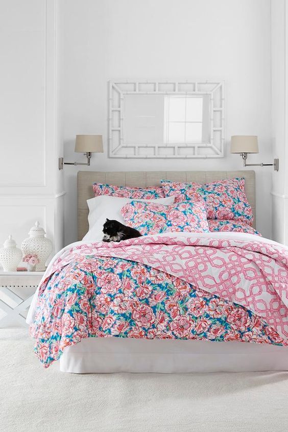 blue and pink floral bedding with geometric patterns on the lining