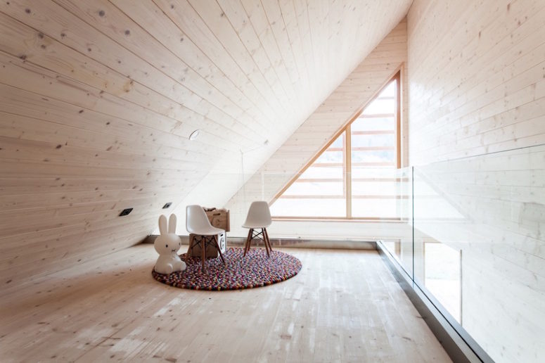 The attic ceiling definitely makes the space feel smaller but it also gives it a cozy feel