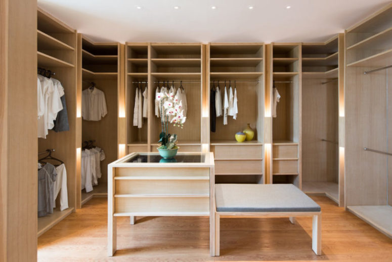 The closet is pure elegance with light-colored wooden wardrobes and an accessory chest, nothing unnecessary here