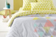 10 a grey duvet with some muted colored triangles and lime triangle print pillowcases
